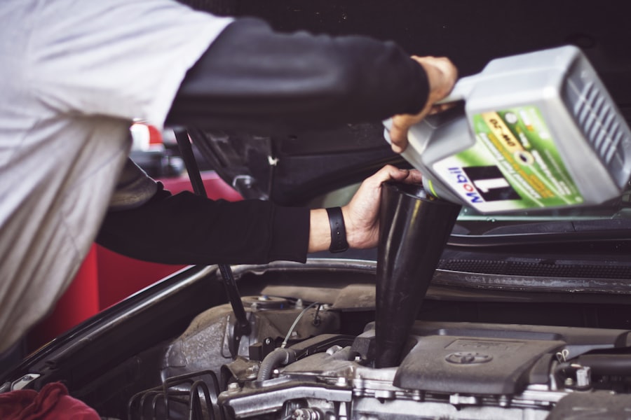 Fresh engine oil being added under a vehicle hood